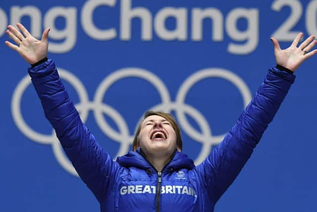Lizzy Yarnold celebrates on the podium during yesterdays medal ceremony. Picture: AFP/Getty