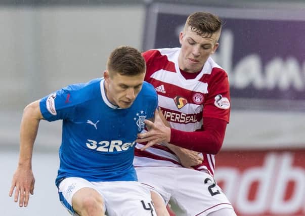 Lewis Ferguson battles with his former team-mate Greg Docherty. Picture: SNS