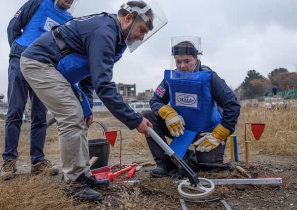 Scottish Conservative leader Ruth Davidson being given training on how to find, excavate and remove landmines by Halo charity staff (Picture: PA)