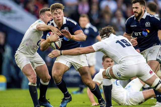 Huw Jones is tackled during Scotland's 61-21 defeat at Twickenham last year. Picture: SNS