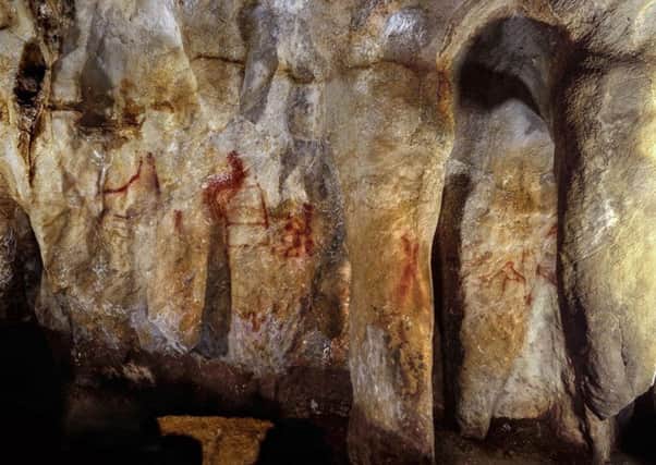 The 64,000-year-old cave paintings show geometric shapes, hand prints and groups of animals. Picture: PA