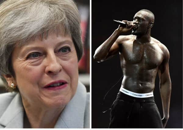Theresa May's spokesperson said the PM was 'absolutely committed' to supporting Grenfell after Stormzy asked 'where's the money' at the Brits. Pictures: PA/Getty