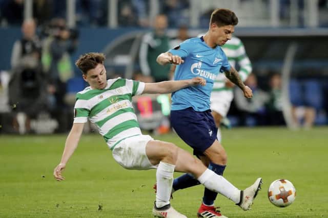 Kieran Tierney, left, competes for the ball with Zenit's Emiliano Rigoni. Picture: AP