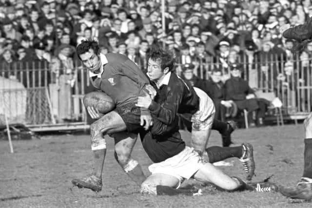 Ian Robertson hangs on to Wales captain Gareth Edwards at Cardiff Arms Park in 1970. Picture:, PA Archive