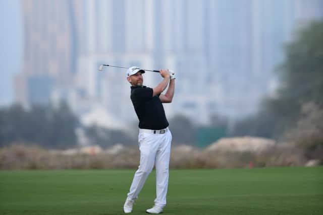 Stephen Gallacher hits his approach shot on the 18th hole in the second round of the Qatar Masters. Picture: Tom Dulat/Getty