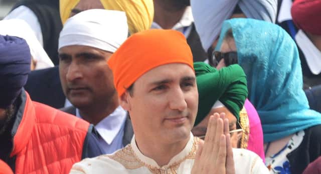 Canadian Prime Minister Justin Trudeau (C) pays his respects at the Sikh Shrine Golden temple in Amritsar on February 21, 2018.
Trudeau and his family are on a week-long official trip to India. / AFP PHOTO / NARINDER NANUNARINDER NANU/AFP/Getty Images