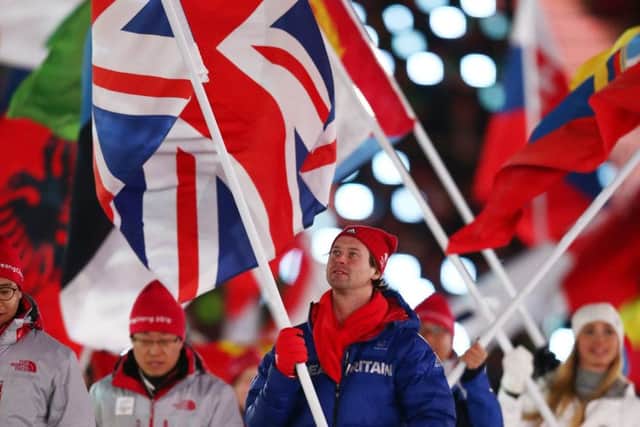 Great Britain flag bearer Billy Morgan walks during the closing ceremony of the Winter Olympics. Picture: Getty.