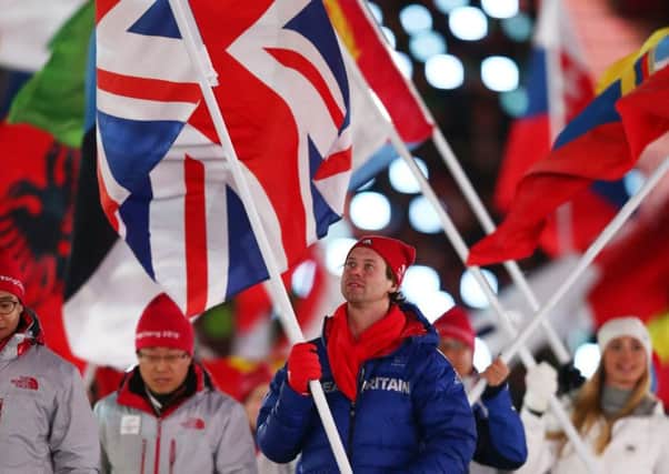 Great Britain flag bearer Billy Morgan walks during the closing ceremony of the Winter Olympics. Picture: Getty.