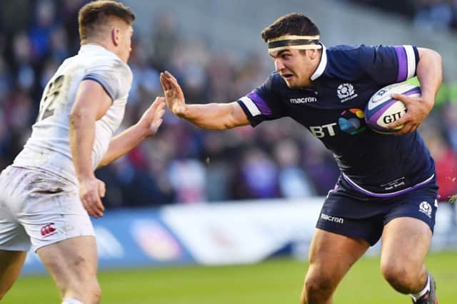 The impressive Stuart McInally tries to hold off the attentions of Owen Farrell during the Six Nations clash. Picture: SNS/SRU