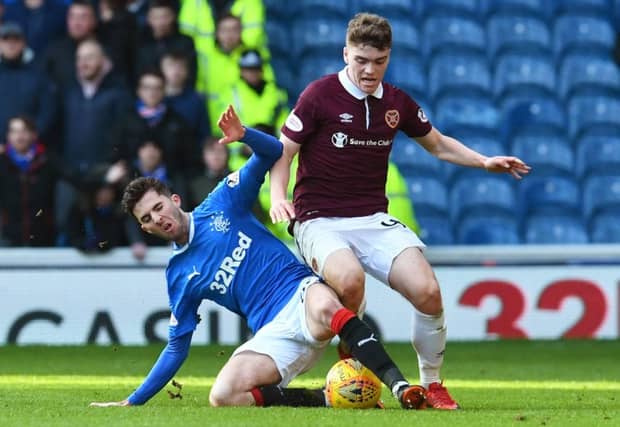 Sean Goss tackles Euan Henderson during Rangers recent 2-0 win over Hearts. Picture: SNS