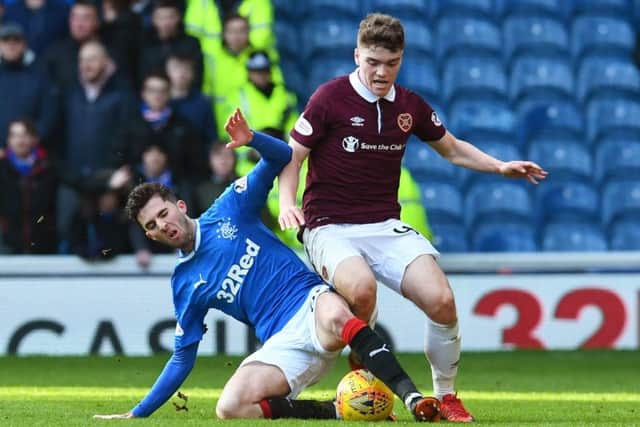 Sean Goss tackles Euan Henderson during Rangers recent 2-0 win over Hearts. Picture: SNS