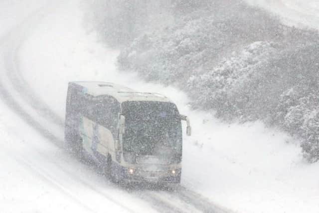 A bus makes its way along the M9 near Falkirk during a blizzard. Picture; PA