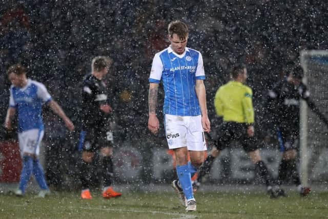 A dejected Jason Kerr as the snow falls during St Johnstone's defeat to Rangers. Picture: PA