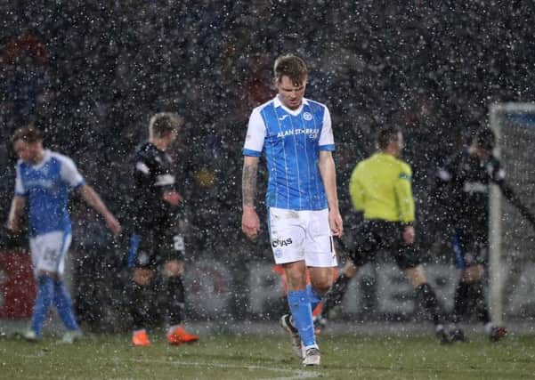 A dejected Jason Kerr as the snow falls during St Johnstone's defeat to Rangers. Picture: PA