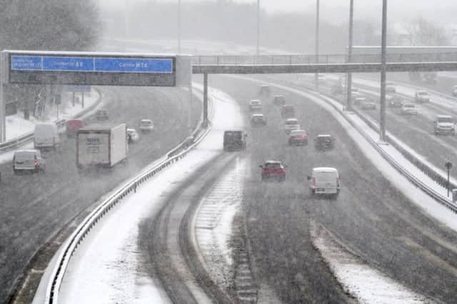 Vehicles drive through snow in Glasgow during poor weather conditions last month