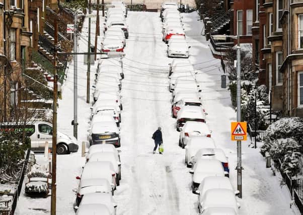 Members of the public make their way through the snow in Gardner Street in Glasgow. Picture: Getty