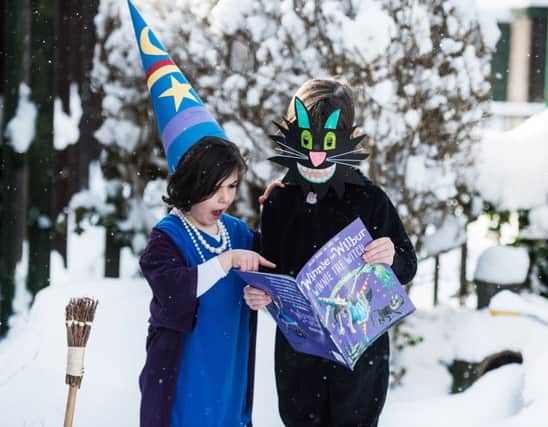 Anan, 6, and Robyn Devlin, 4, with their favourite book film characters Winnie and Wilbur. Picture: John Devlin