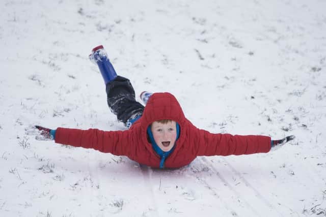 Elijah Rozelle, aged 9, enjoys a snow day in Edinburgh. Picture: SWNS