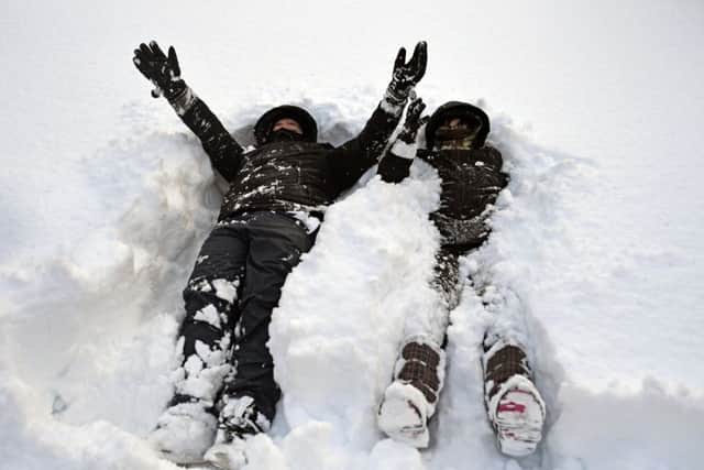 Two boys play in the snow after many schools were closed on Thursday. Picture: Getty
