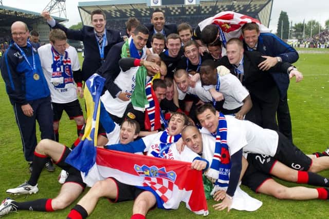 Rangers players celebrate clinching the title by defeating Kilmarnock 5-1 at Rugby Park on the final day of the 2010-11 season. Picture: SNS
