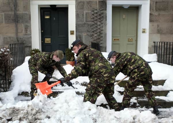 Army personnel from 1 SCOTS clear snow from roads around the Royal Hospital for Sick Children in Edinburgh