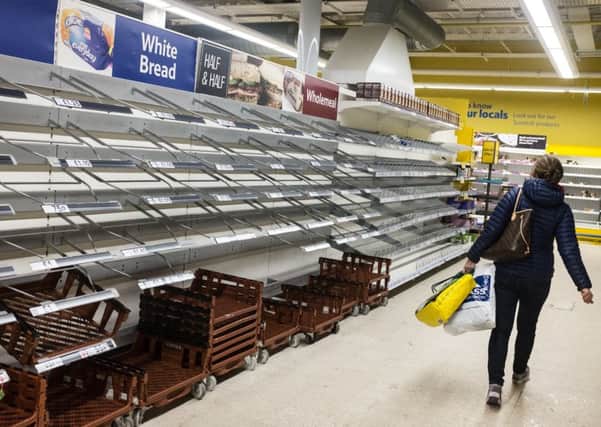 Empty supermarket shelves in Glasgow bear witness to the chaos. Picture: John Devlin
