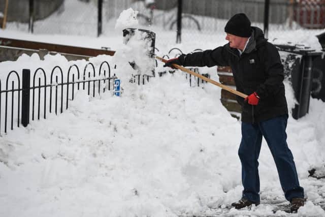 Residents clear snow from their homes in Alexandria, Scotland. Picture: Jeff J Mitchell/Getty Images