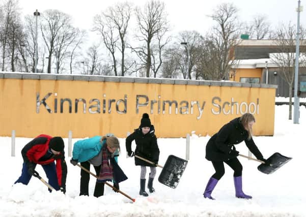 Parents, teachers and the local community of Larbert in Scotland begin clearing the grounds of Kinnaird Primary School, as the cold weather continues around the country. Picture: Andrew Milligan/PA Wire