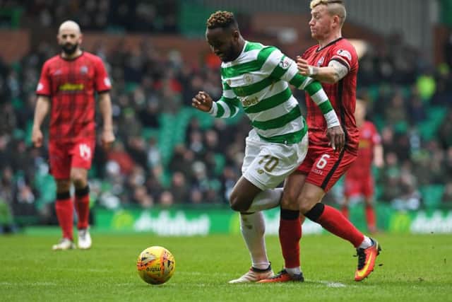 Celtic's Moussa Dembele challenge for the ball with Morton's Michael Doyle. Picture: SNS/Craig Foy