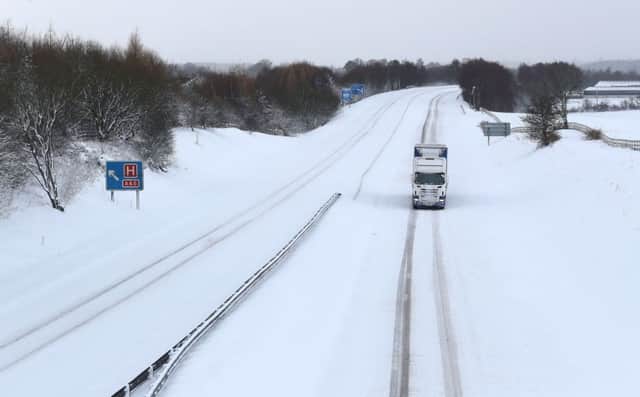 A lone lorry braves the M876. Picture: PA