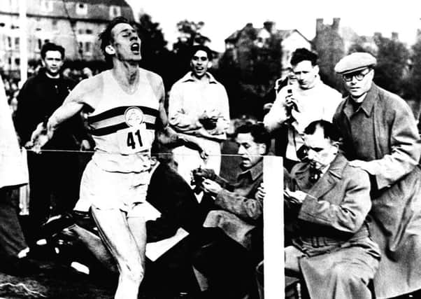 Roger Bannister crossing the line as he completes the world's first four minute mile. Picture: PA