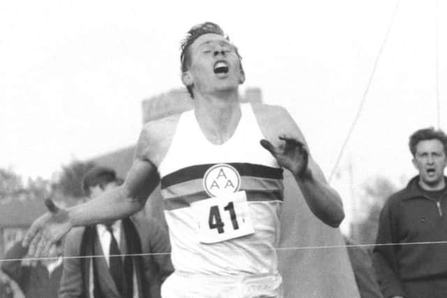 Roger Bannister hits the tape to break the four-minute mile in 1954. Picture: AP