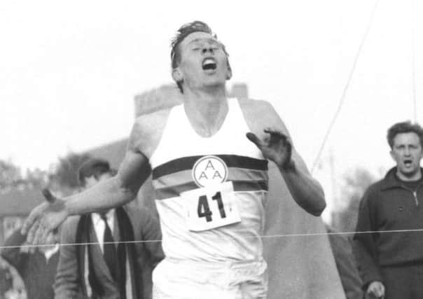 Roger Bannister hits the tape to break the four-minute mile in 1954. Picture: AP