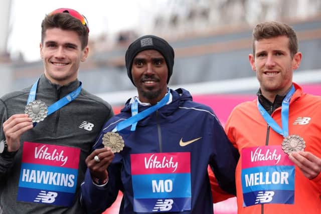 Winner Mo Farah, centre, poses with third-placed Callum Hawkins, left, and Jonny Mellor after the Big Half in London. Picture: AFP/Getty