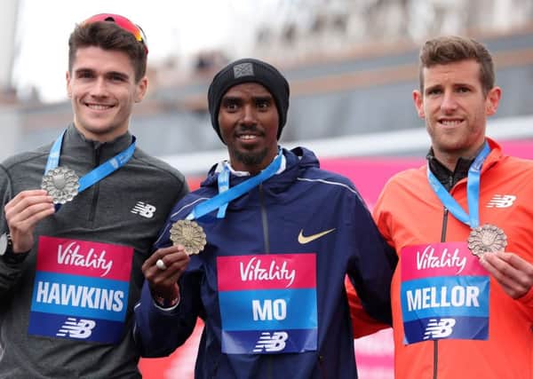 Winner Mo Farah, centre, poses with third-placed Callum Hawkins, left, and Jonny Mellor after the Big Half in London. Picture: AFP/Getty