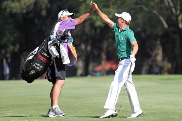 Justin Thomas celebrates with his caddie after holing out for an eagle-2 at the 72nd hole in Mexico City. Picture: Getty Images