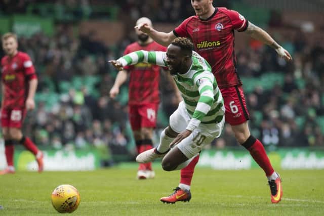 Moussa Dembele goes down under the challenge from Morton's Michael Doyle. Picture: SNS