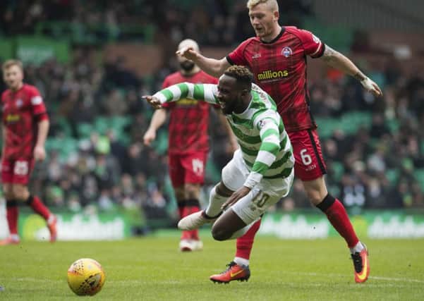 Moussa Dembele goes down under the challenge from Morton's Michael Doyle. Picture: SNS