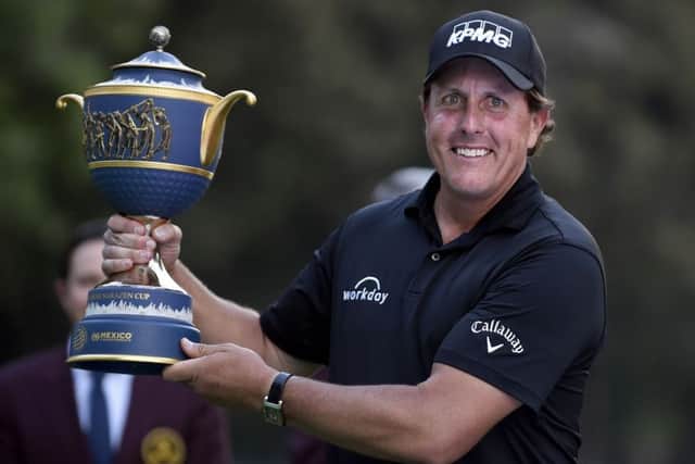 Phil Mickelson holds the trophy aloft at the 18th after winning the World Golf Championship in Mexico City. Picture: Alfredo Estrella/AFP/Getty Images