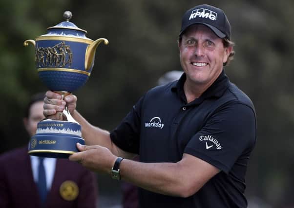 Phil Mickelson holds the trophy aloft at the 18th after winning the World Golf Championship in Mexico City. Picture: Alfredo Estrella/AFP/Getty Images