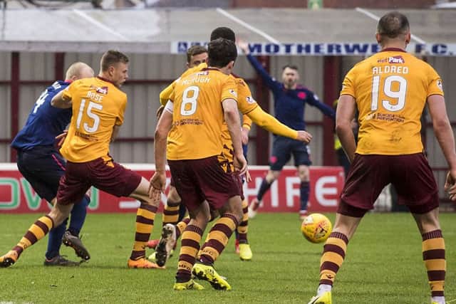 Hearts' appeal for a penalty after the ball appears to strike the arm of Andy Rose (second left). Picture: SNS