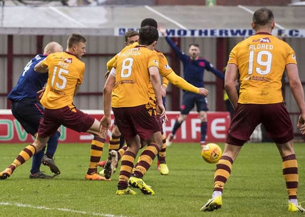 Hearts' appeal for a penalty after the ball appears to strike the arm of Andy Rose (second left). Picture: SNS