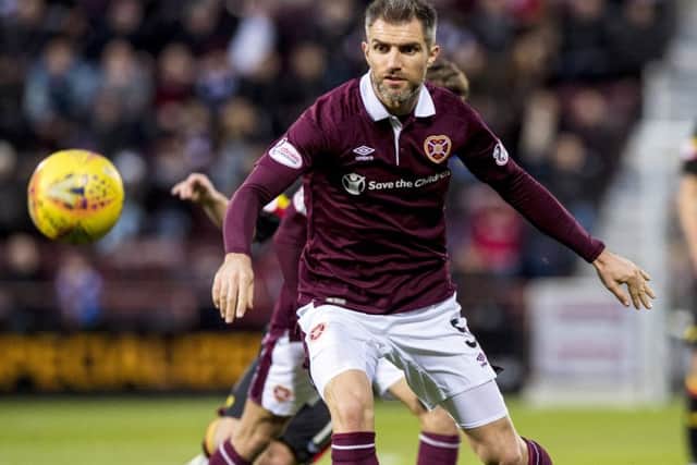 Aaron Hughes is not ready to accept that Hearts cannot make up the nine-point gap separating them from Hibs. Picture: SNS.