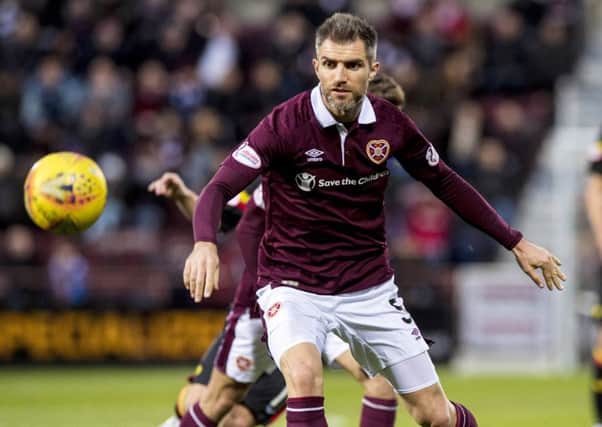 Aaron Hughes is not ready to accept that Hearts cannot make up the nine-point gap separating them from Hibs. Picture: SNS.