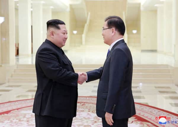 Picture released from North Korea's official Korean Central News Agency (KCNA) on March 6, 2018 shows North Korean leader Kim Jong-Un (L) shaking hands with South Korean chief delegator Chung Eui-yong. Picture; Getty