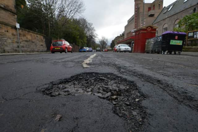 Potholes have become a blight on Scotland's roads and a trial taking place in Fife could pose a solution. Picture: Jon Savage