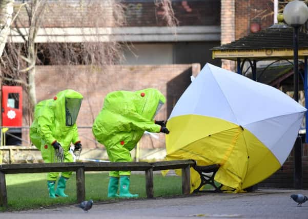 Emergency services cover the bench where Sergei Skripal and his daughter Yulia were found. Picture: Getty