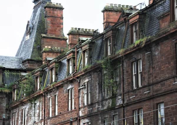The stonework of the Station Hotel in Ayr is deteriorating, with bushes growing from its walls.