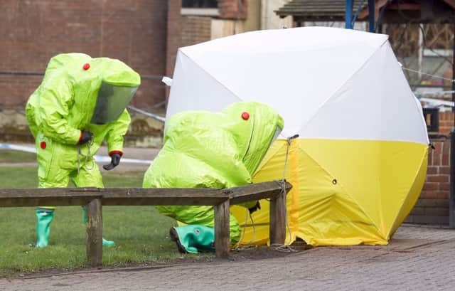 Personnel in hazmat suits work to secure a tent covering a bench in the Maltings shopping centre in Salisbury, where former Russian double agent Sergei Skripal and his daughter Yulia were found critically ill by exposure to a nerve agent. Picture: Andrea Matthews