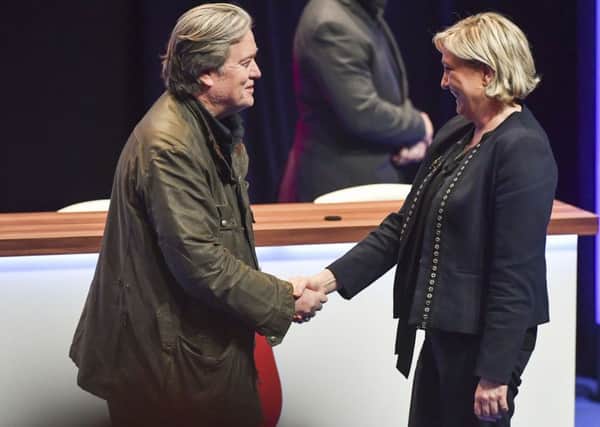 National Front party leader Marine Le Pen, right, greets on stage former White House strategist Steve Bannon at the party congress in the northern French city of Lille. Picture: AP Photo